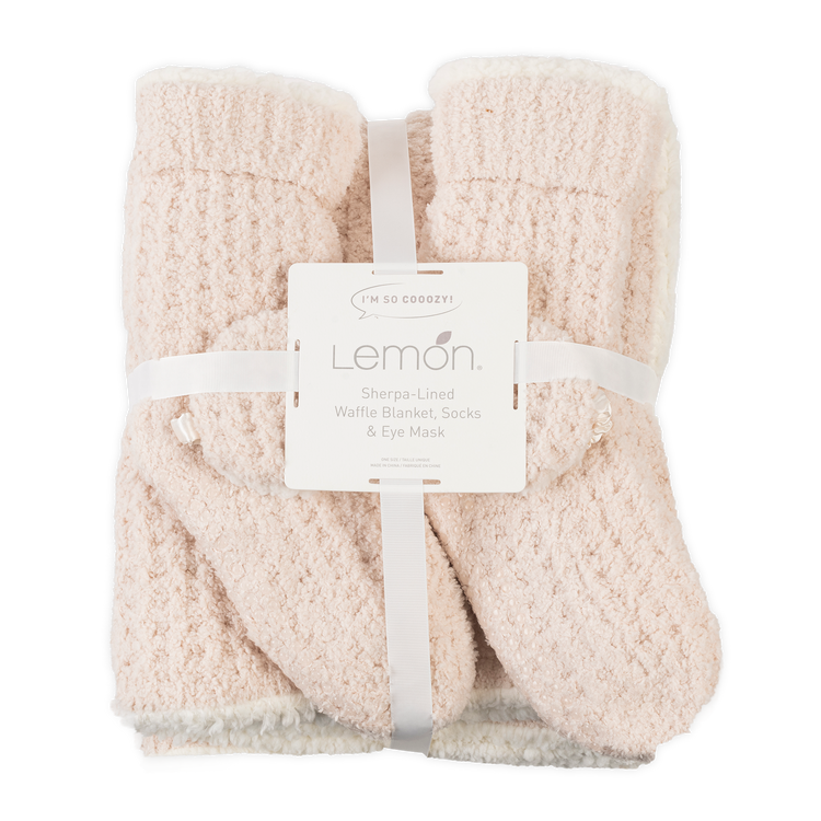 Set of cream-colored fleece-lined socks with a matching eye mask, branded 'Lemon', on a white background.