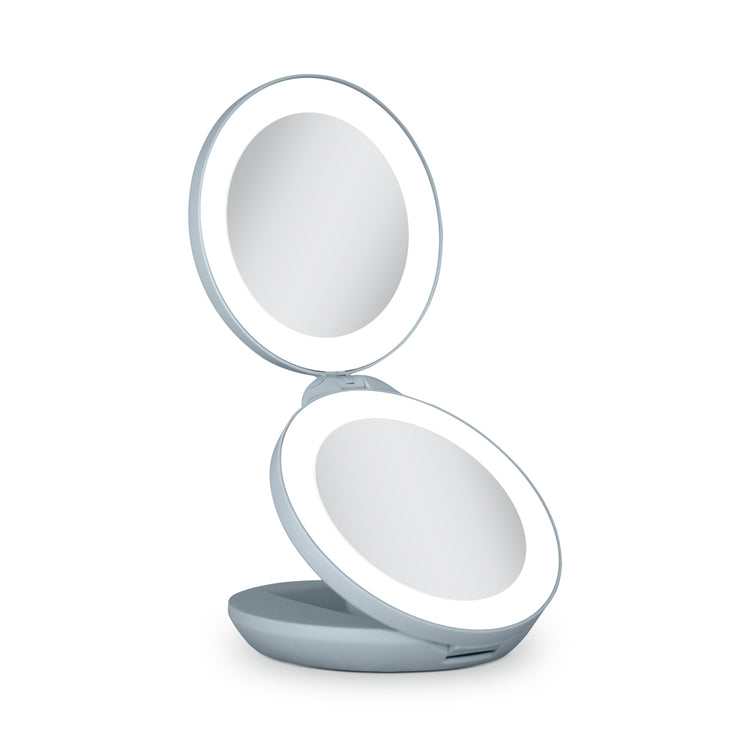 Compact mirror with a light on a white background
