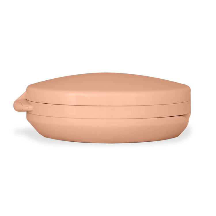 Beige ceramic dish with lid on a white background