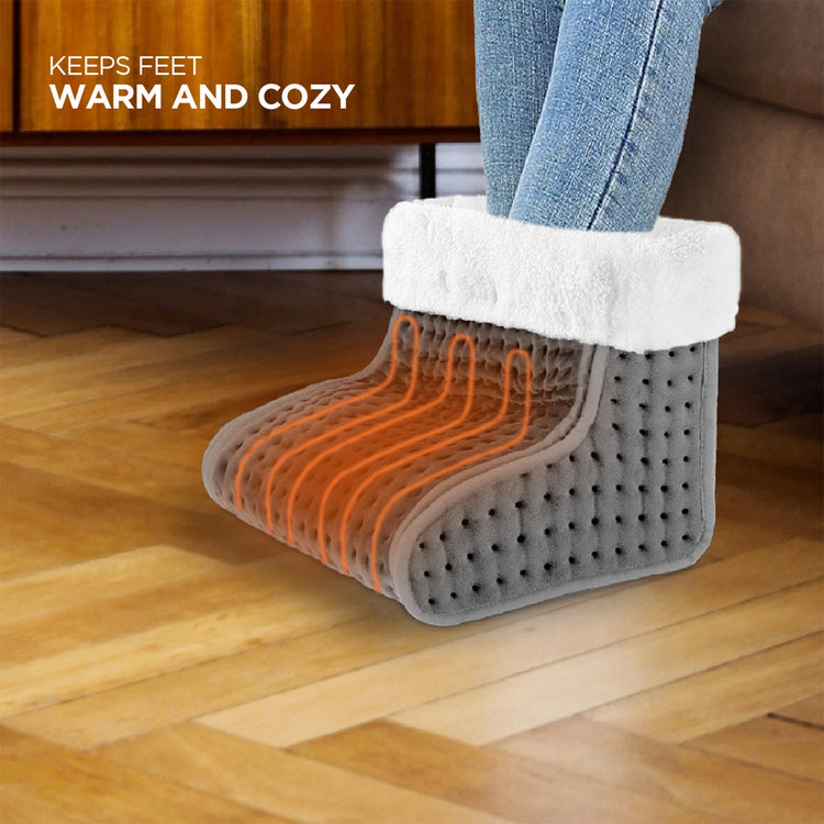 Foot warmer with orange heating elements on a wooden floor.