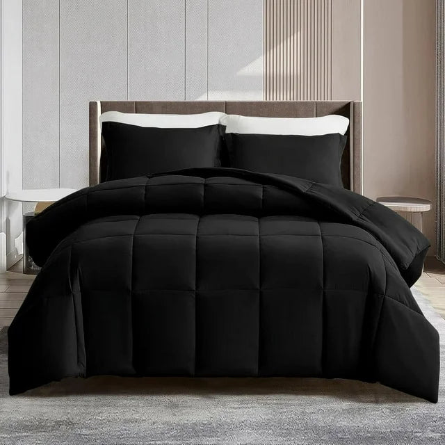 Black quilted comforter set on a bed in a bedroom setting
