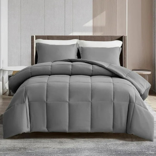 Gray comforter set on a bed in a bedroom setting