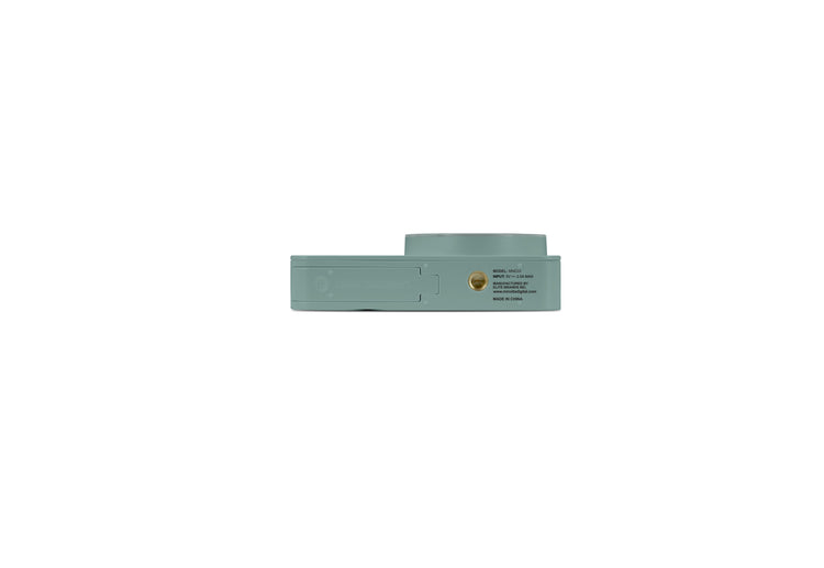 Silver ring with green gemstones on a white background with measurement scale