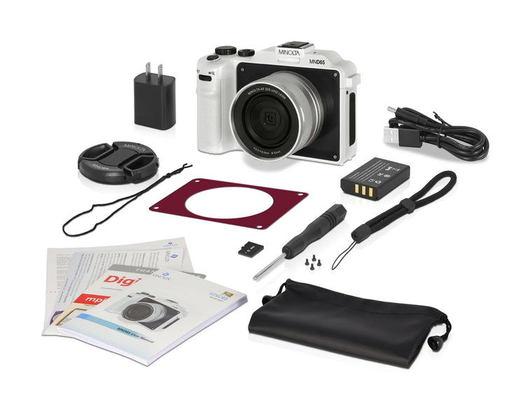 Camera kit with camera, accessories, and documentation on a white background