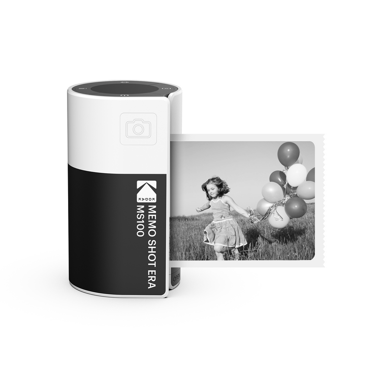 A Kodak MemoShot ERA Instant Digital Camera and Label Printer with a printed black and white photo of a child with balloons next to it.