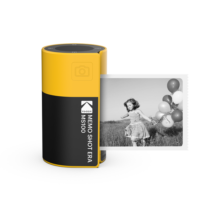 A Kodak MemoShot ERA Instant Digital Camera and Label Printer with a printed black and white photo of a child with balloons next to it.