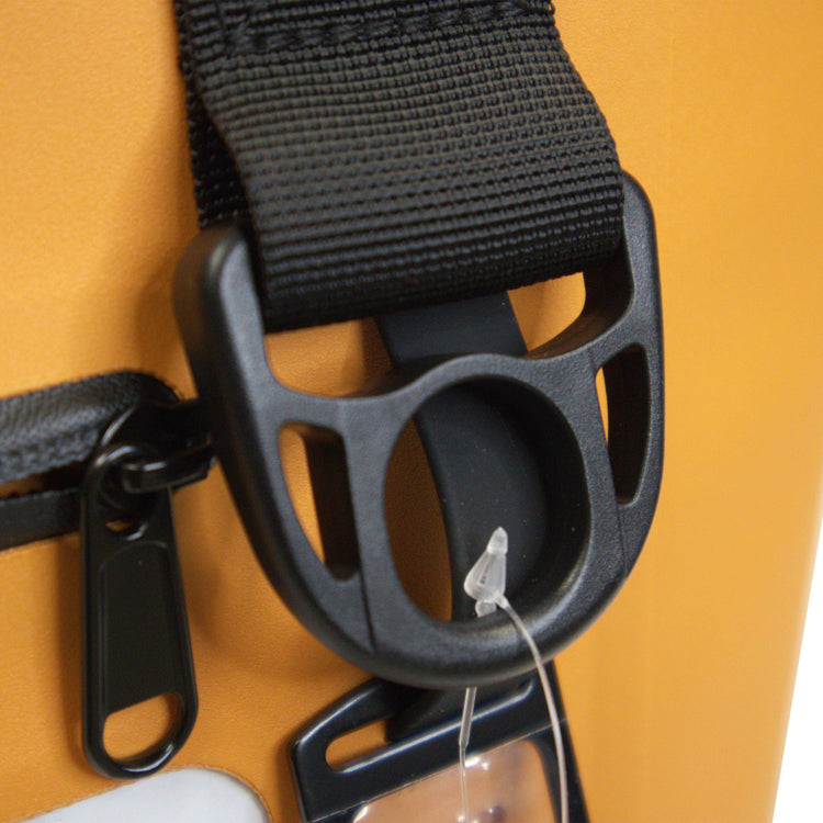 Close-up of a black strap with a buckle on a yellow background