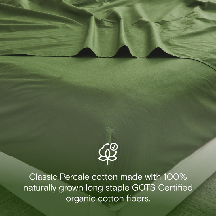 Green bed sheets with GOTS certification logo and text on a bed.