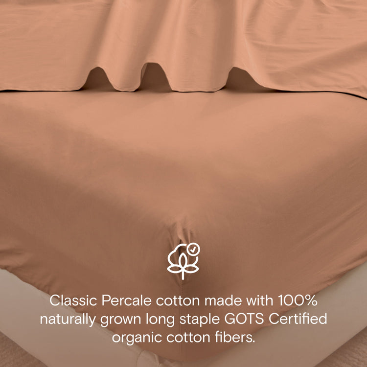 Brown bed sheets with GOTS certification logo and text on a neutral background