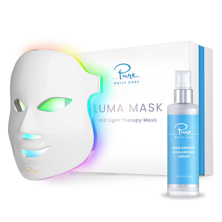 A LED light therapy facial mask and a bottle of high energy hyaluronic serum, both branded by Pure Daily Care, with the mask illustrated in a rainbow of light colors and the serum bottle labeled.