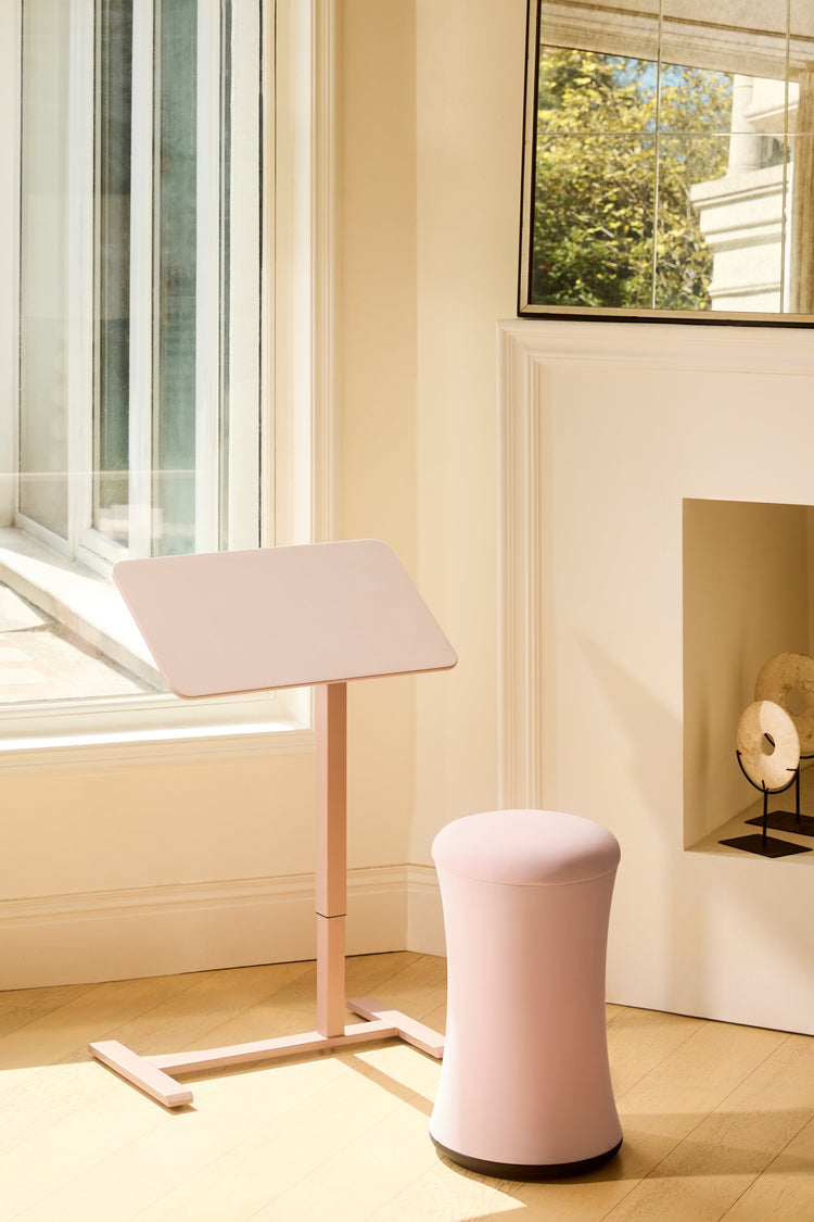 Pink adjustable stand and stool in a room with a window and mirror.