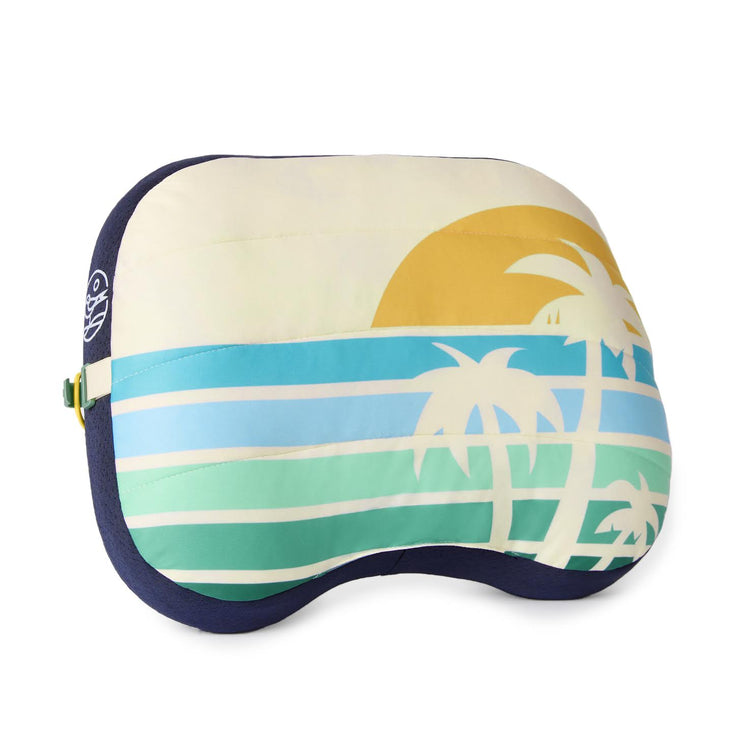 Travel pillow with tropical design featuring palm trees and a sunset on a white background