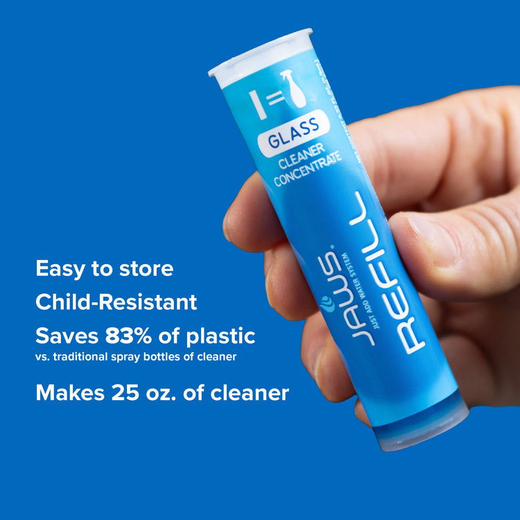 Hand holding a blue glass cleaner concentrate refill tube with text on a blue background