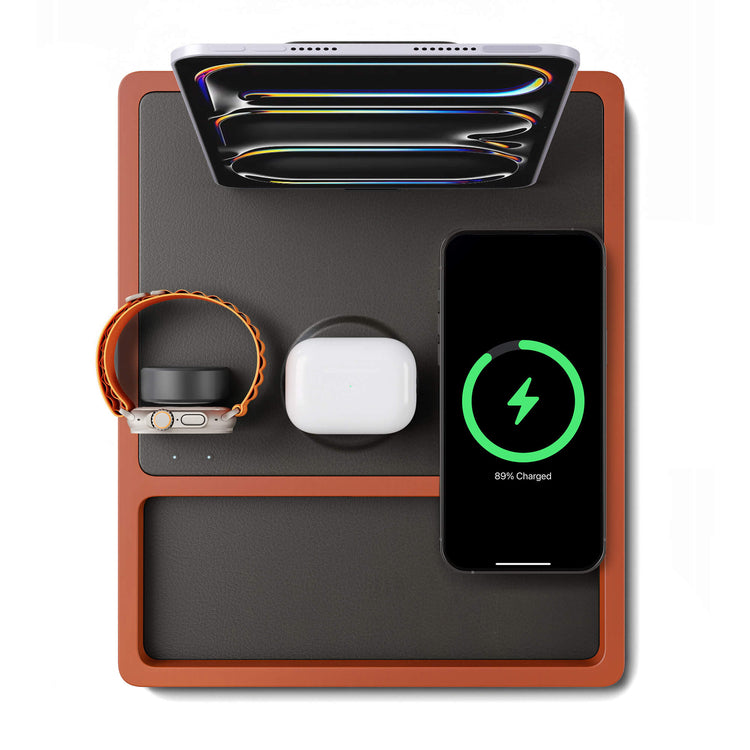 A 4-in-1 MagSafe oak wireless charger with a black and brown color scheme, featuring a section for charging an Apple Watch, a smartphone, and additional wireless charging pads.