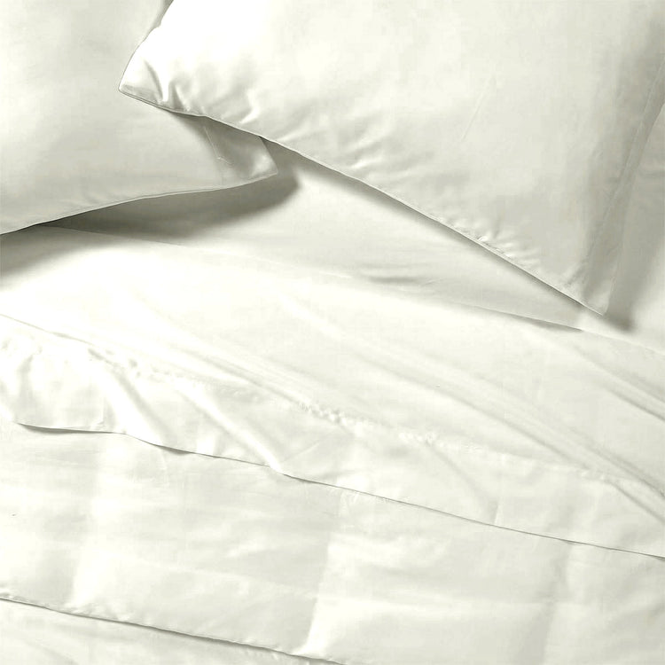 White satin pillowcases on a white bedspread