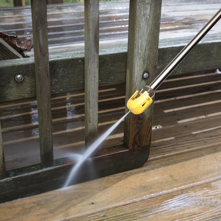 Pressure washer cleaning a wooden deck with water spraying out.