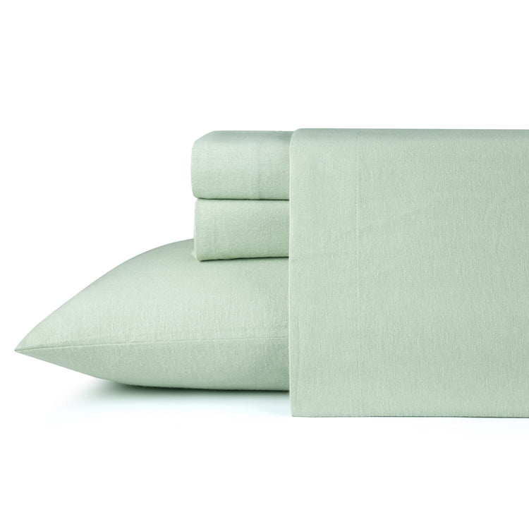 Set of light green bed sheets and pillowcase on a white background