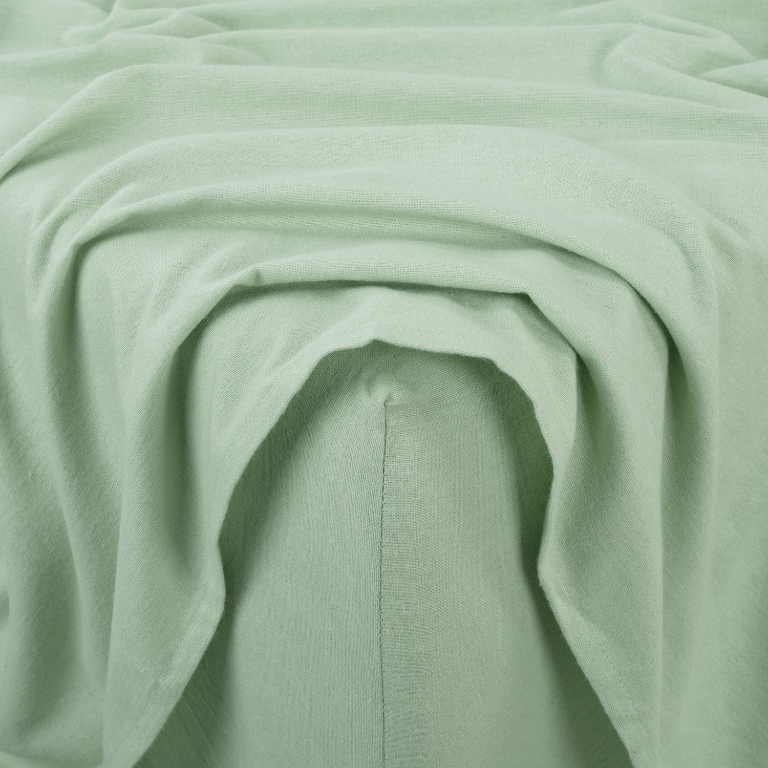 Close-up of light green fabric with folds