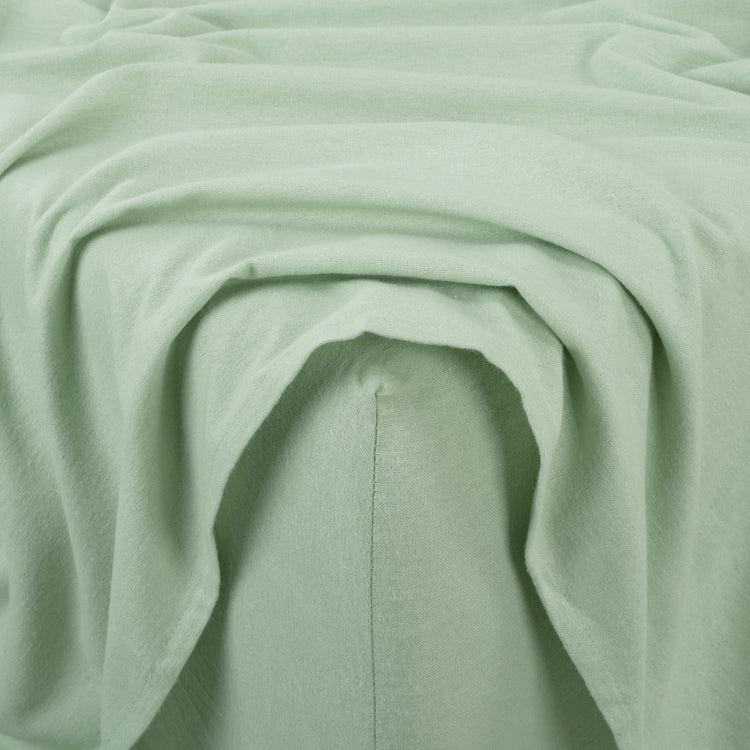 Close-up of light green fabric with folds
