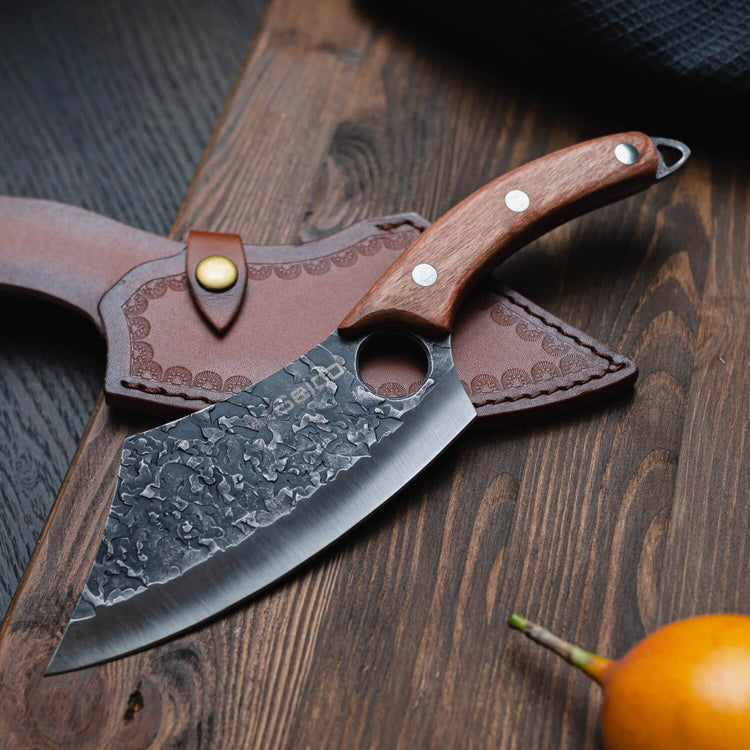 Knife with wooden handle and leather sheath on a wooden surface