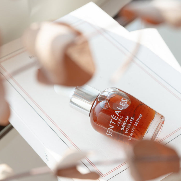 Serum bottle on a white surface with blurred background
