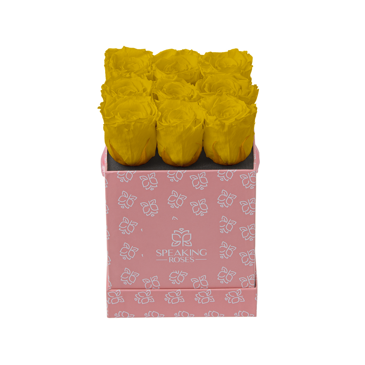 Pink box with yellow roses on a white background