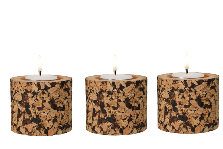 Three candle holders made of cork on a white background