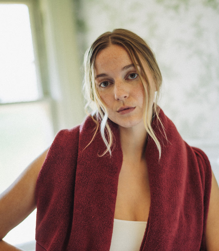 Woman wearing a red scarf with a blurred indoor background