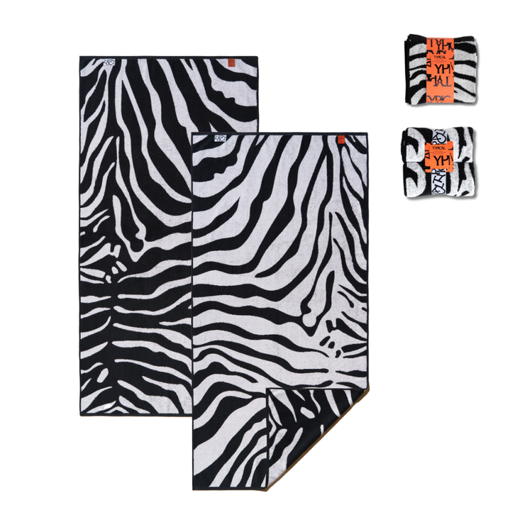 Zebra patterned towel set with small pouches on a white background