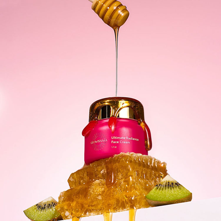 Pink face cream jar with honey drizzle and kiwi slices on a pink background