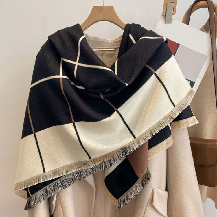 An extra-large pashmina in a checkered pattern of black, beige, gray, and pink, with fringes at the ends.