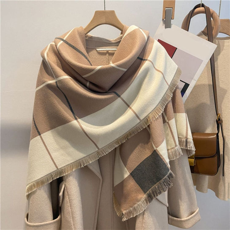 An extra-large pashmina in a checkered pattern of black, beige, gray, and pink, with fringes at the ends.