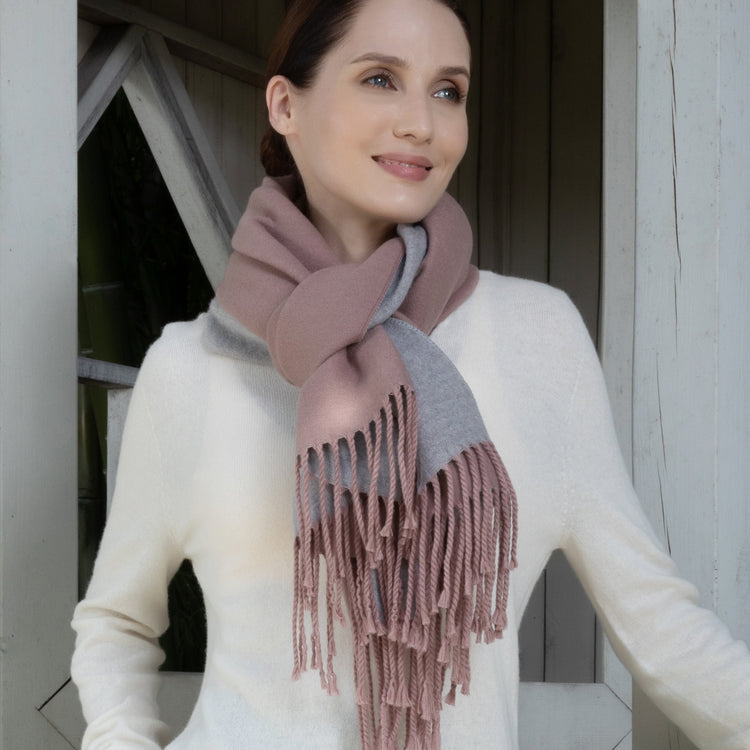 Woman wearing a pink and gray scarf with a blurred background