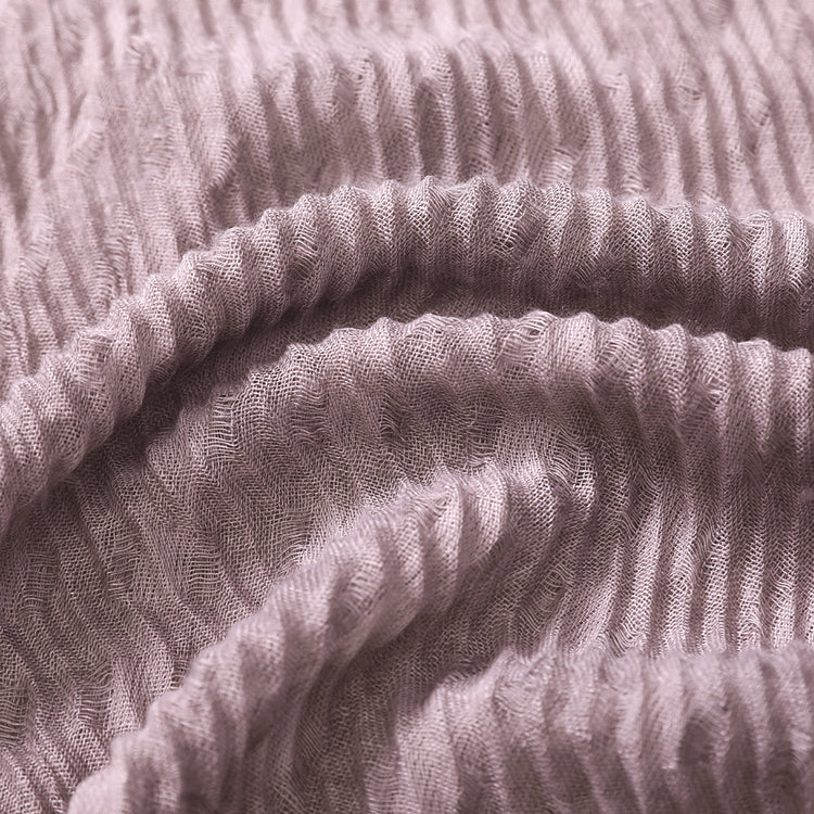 Close-up of textured pink fabric with a ribbed pattern