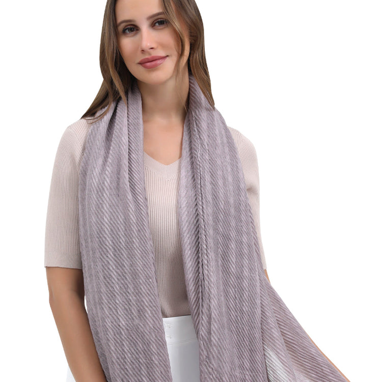 Woman wearing a light gray scarf on a white background