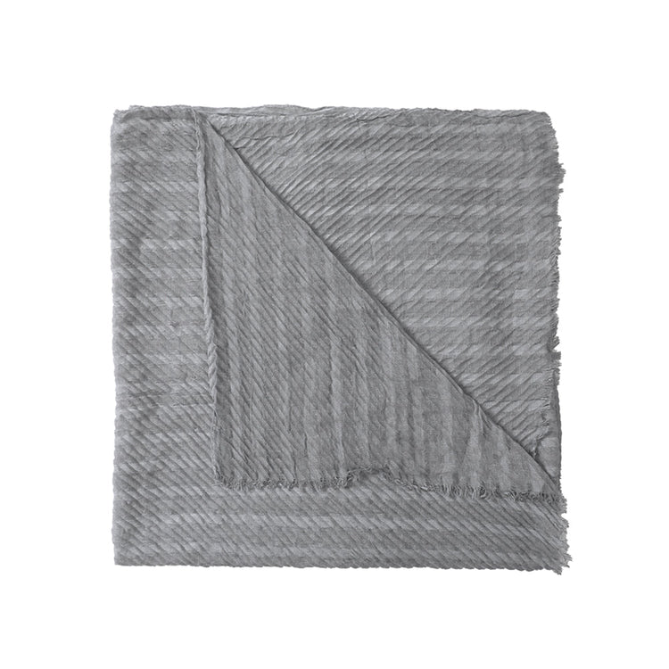 Gray textured blanket folded on a white background