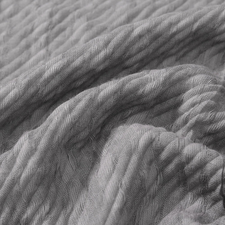 Close-up of textured gray fabric with folds