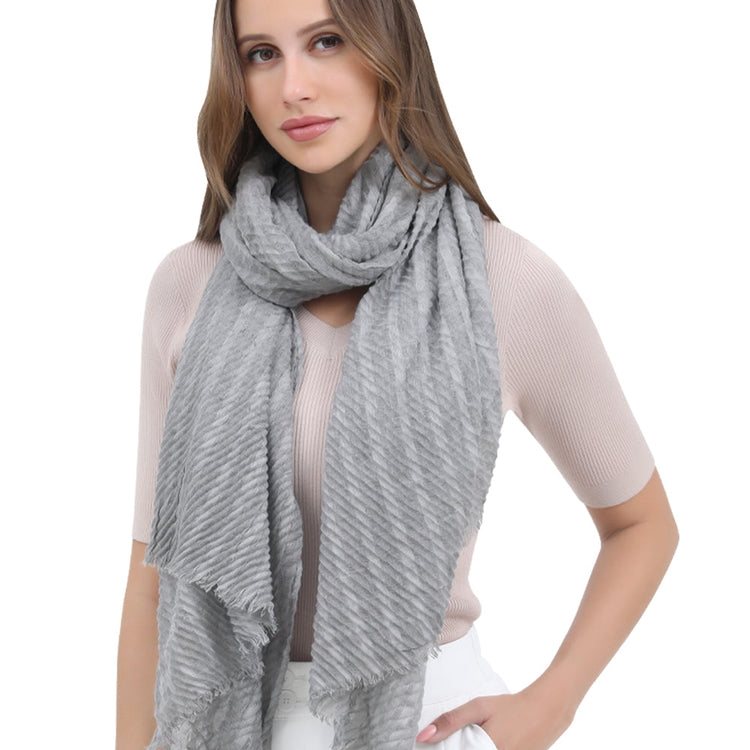 Woman wearing a gray scarf on a white background