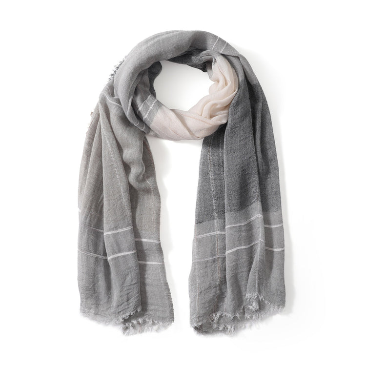 A gray and white striped scarf with frayed edges displayed on a plain background.