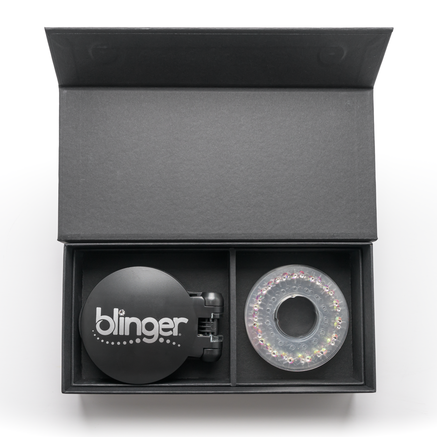 A blinger Vanity Starter Set with a styling tool and a circle of precision-cut glass crystals inside a deluxe black vanity storage case.