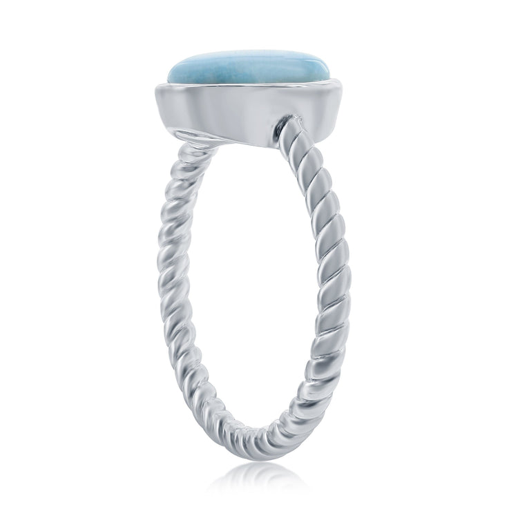 Silver ring with a textured band and light blue stone on a white background