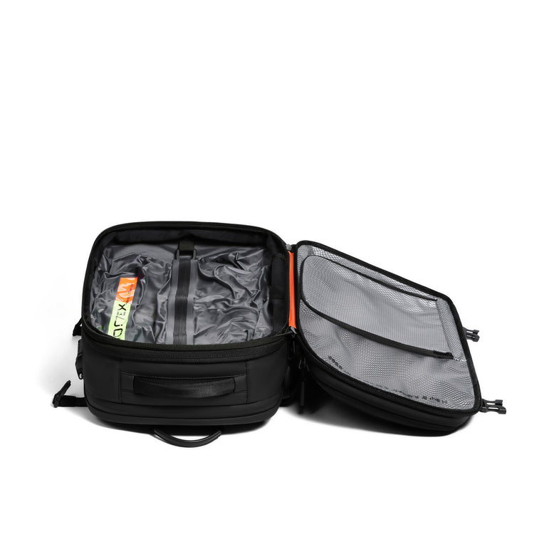 Black backpack with open compartment showing gray interior on a white background