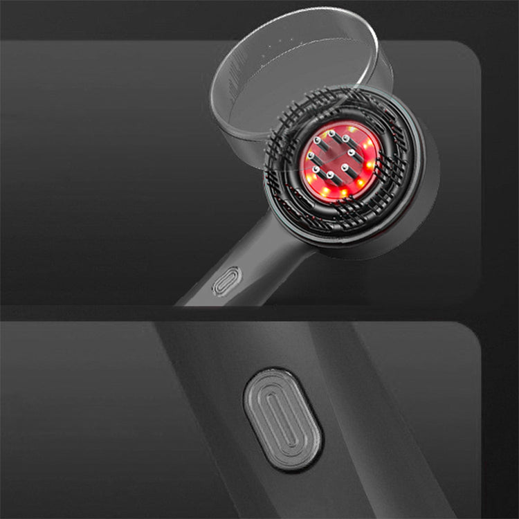 Close-up of a black handheld device with a red light on a dark background