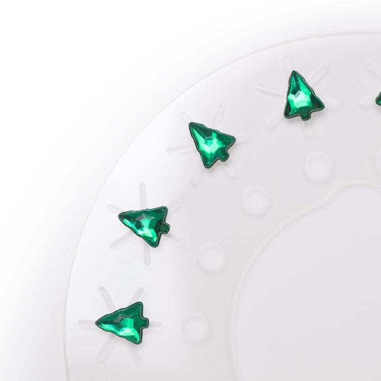 Green tree-shaped rhinestones on a white background