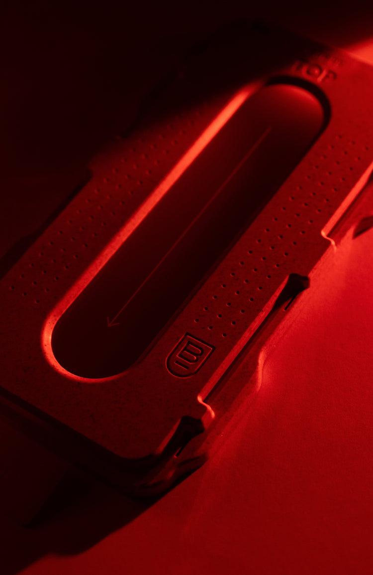 Close-up of a red tool with a visible brand logo on a dark background