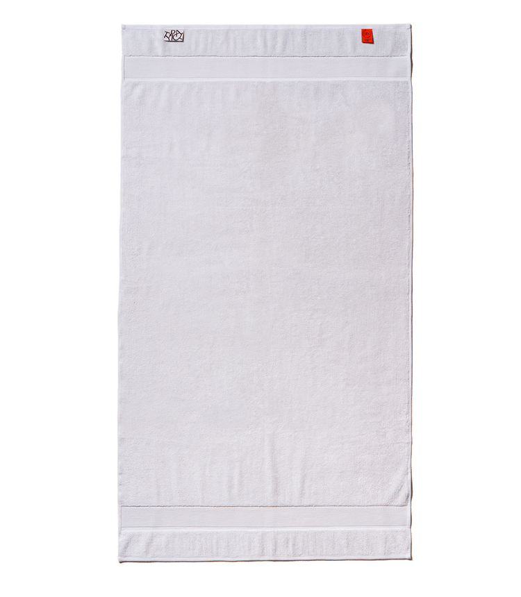White towel with a brand label on a black background