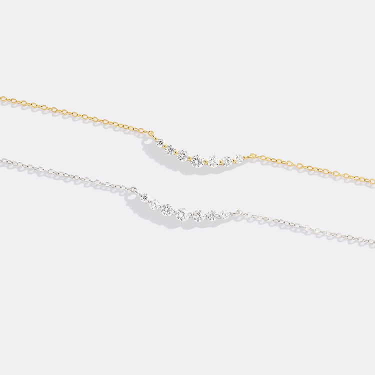 Two gold necklaces on a white background