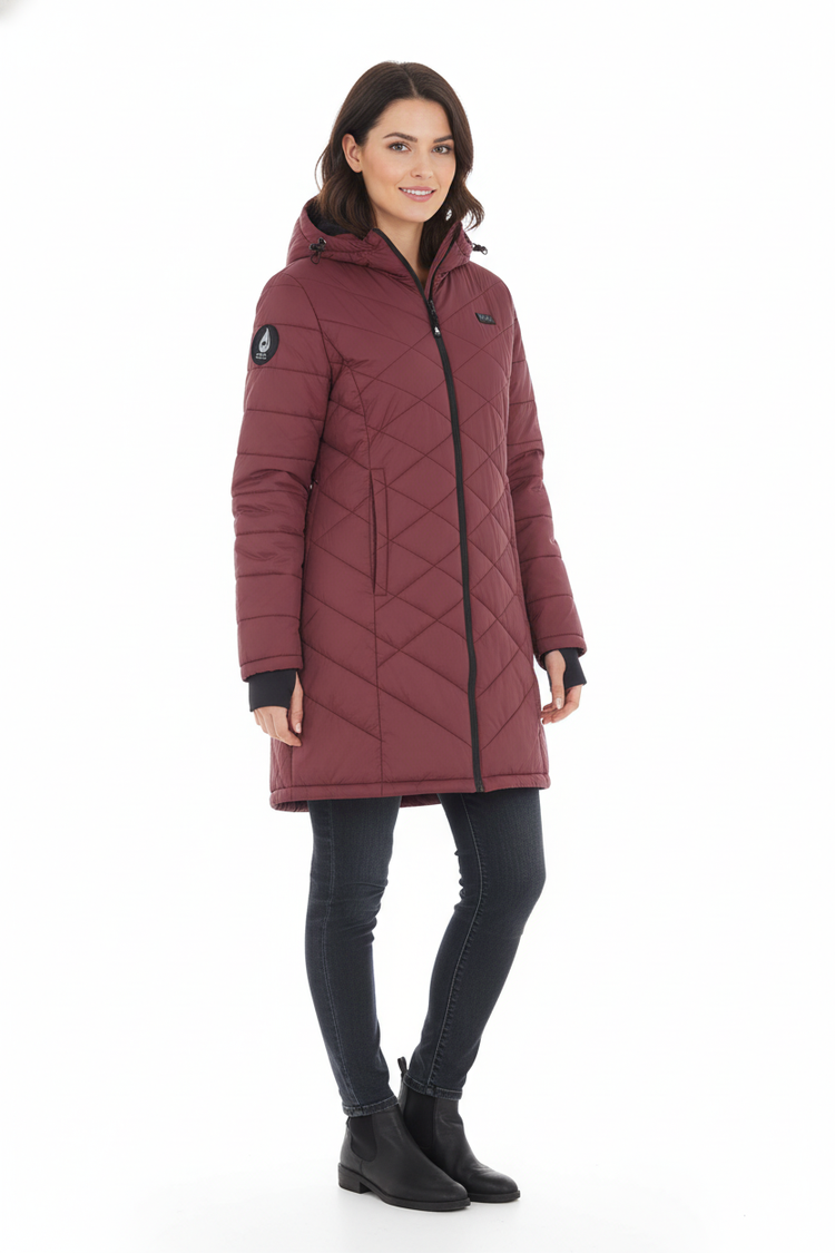 Woman wearing a maroon quilted jacket on a white background