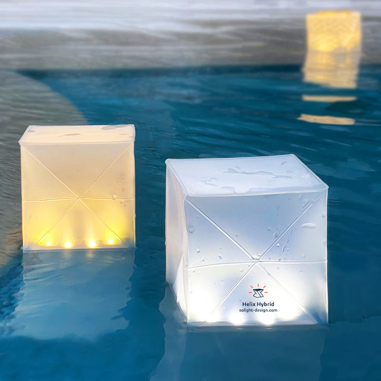 Helix Hybrid solar lanterns in pool glowing in warm and bright light modes