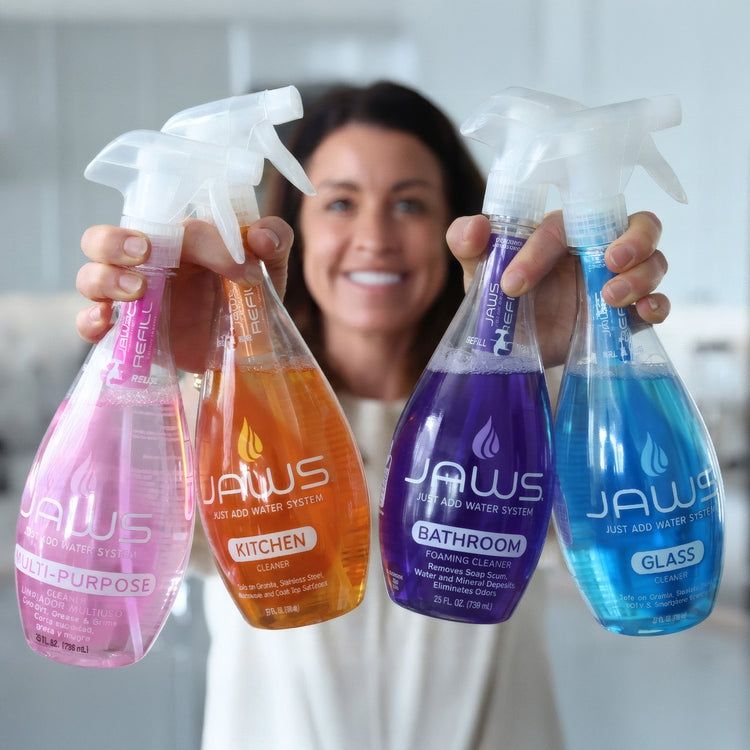 Person holding four JAWS cleaning product bottles in different colors.
